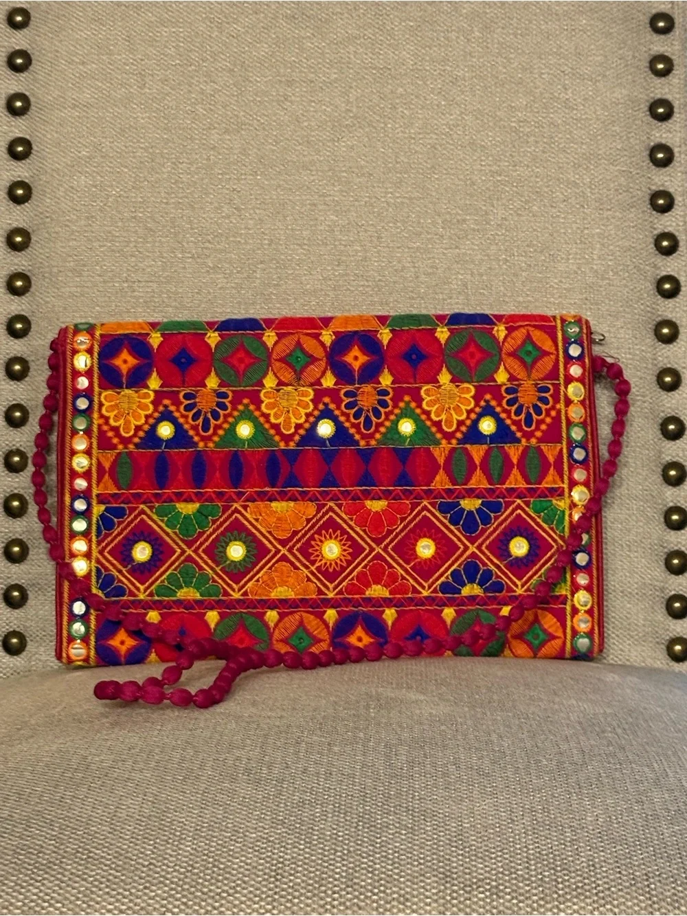 Multicolor Embroidered Fold-Over Clutch with Pom-Pom Strap